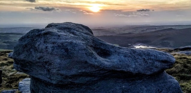 gritstone rock at sunset on kinder peak district england